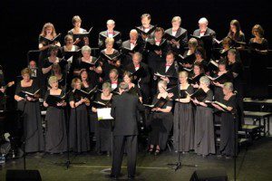 A choir is standing in front of the audience.