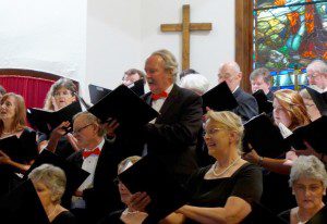 A choir of people in black and red outfits.